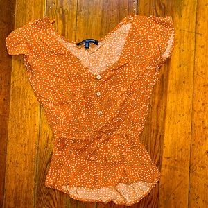 This is an x-small orange and white polka dot top. It is from One ❤️ Clothing.